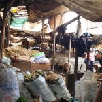 A market stall with sacks of produce